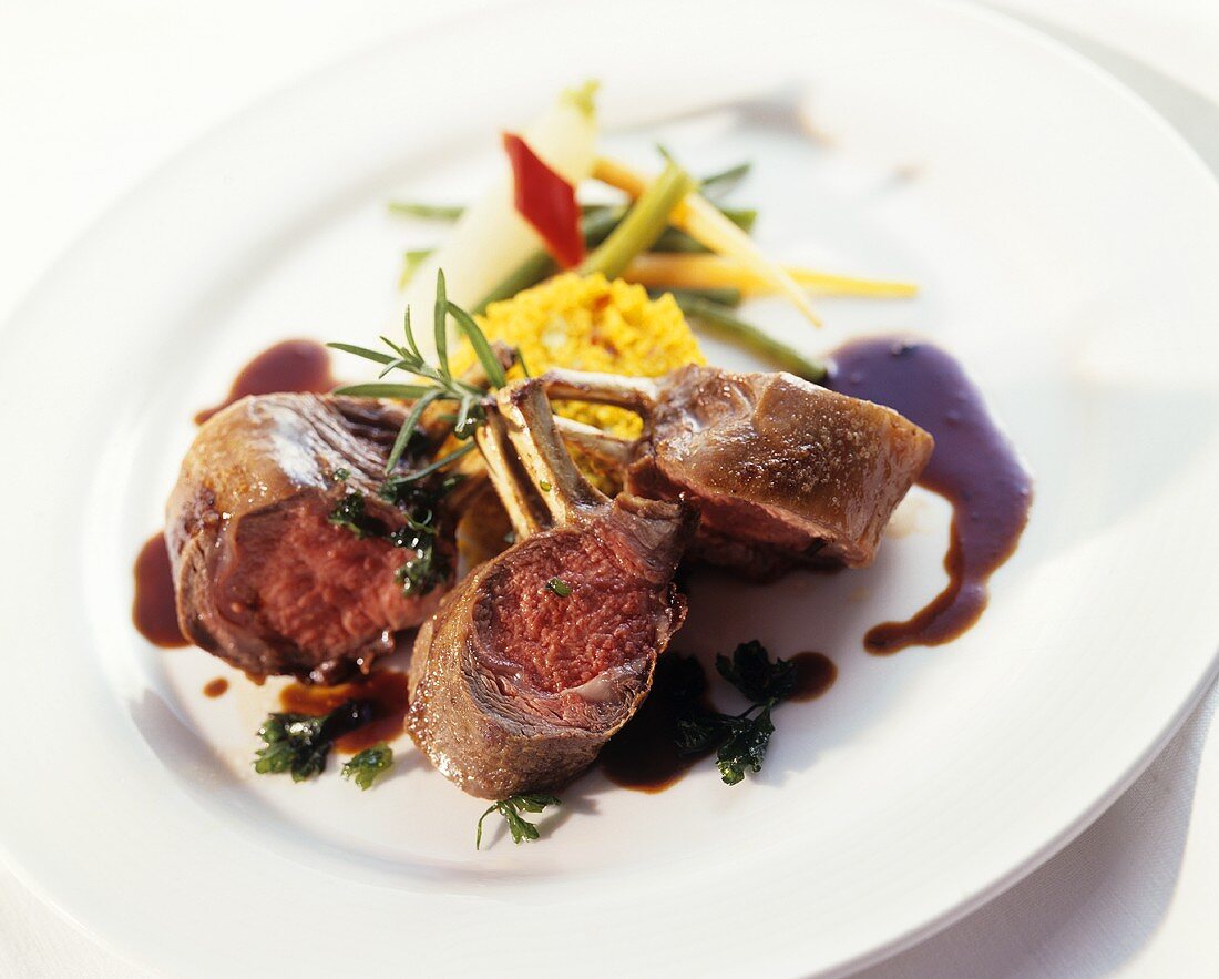 Pieces of rack of lamb with saffron couscous and vegetables
