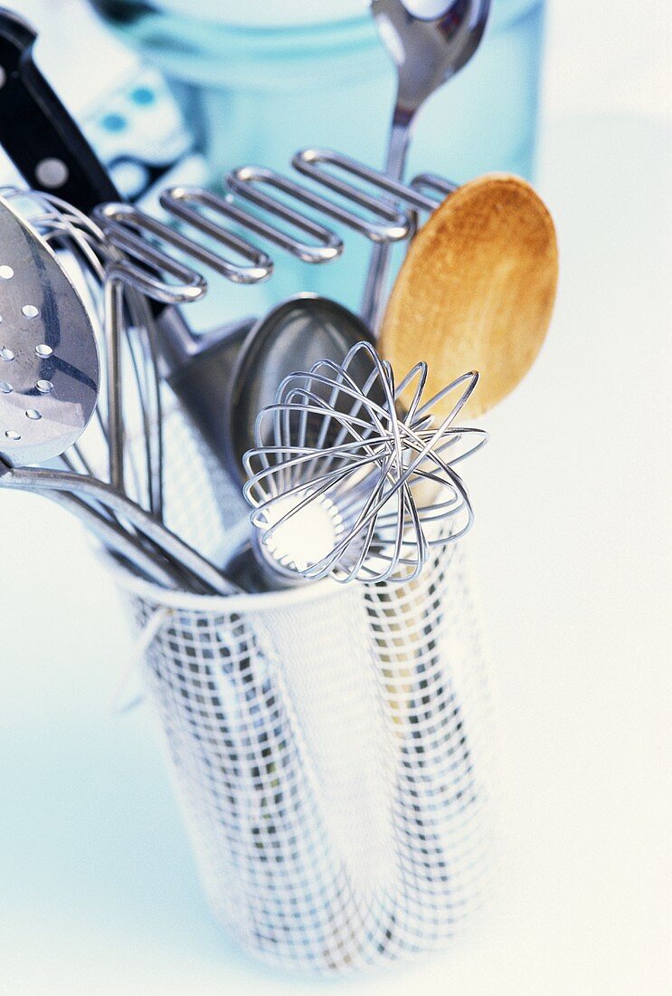 Various kitchen tools in a cutlery drainer