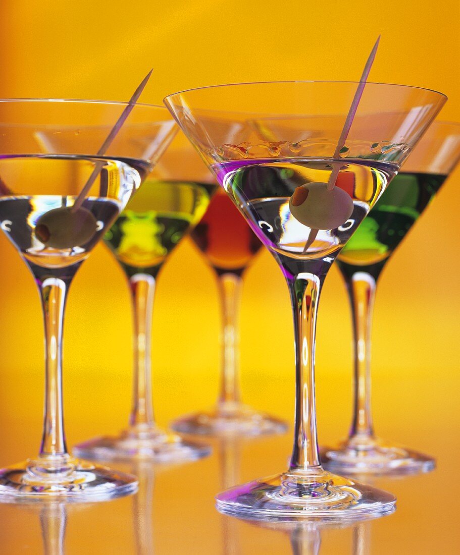 Coloured drinks in Martini glasses