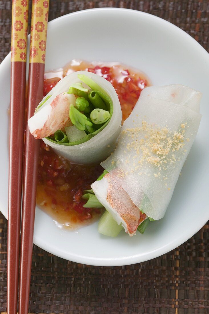 Vietnamese spring rolls with asparagus, shrimps, chili sauce