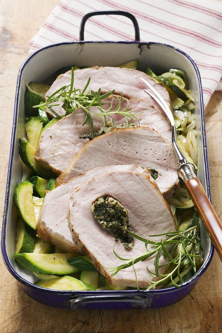 Loin of pork with herb stuffing on courgettes