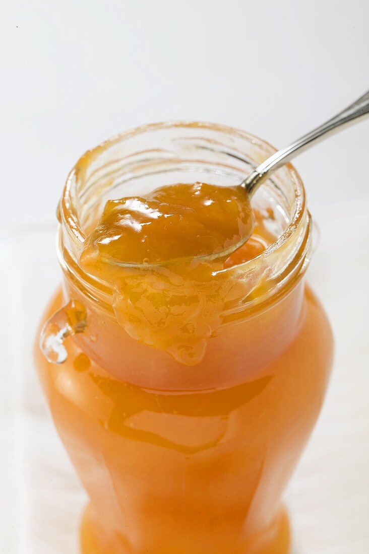 Apricot jam in jar with spoon