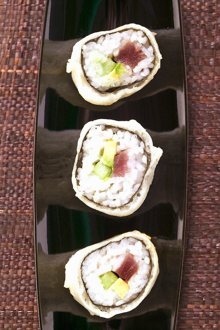 Maki sushi with tuna, cucumber and avocado