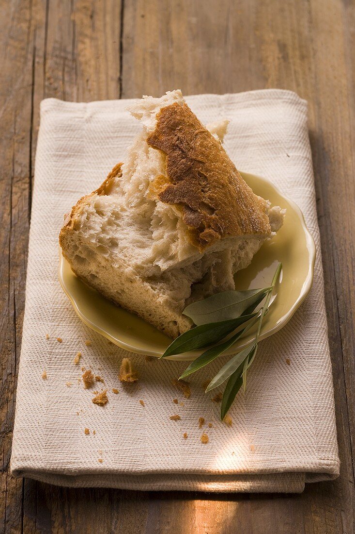 Pieces of white bread on plate with olive sprig