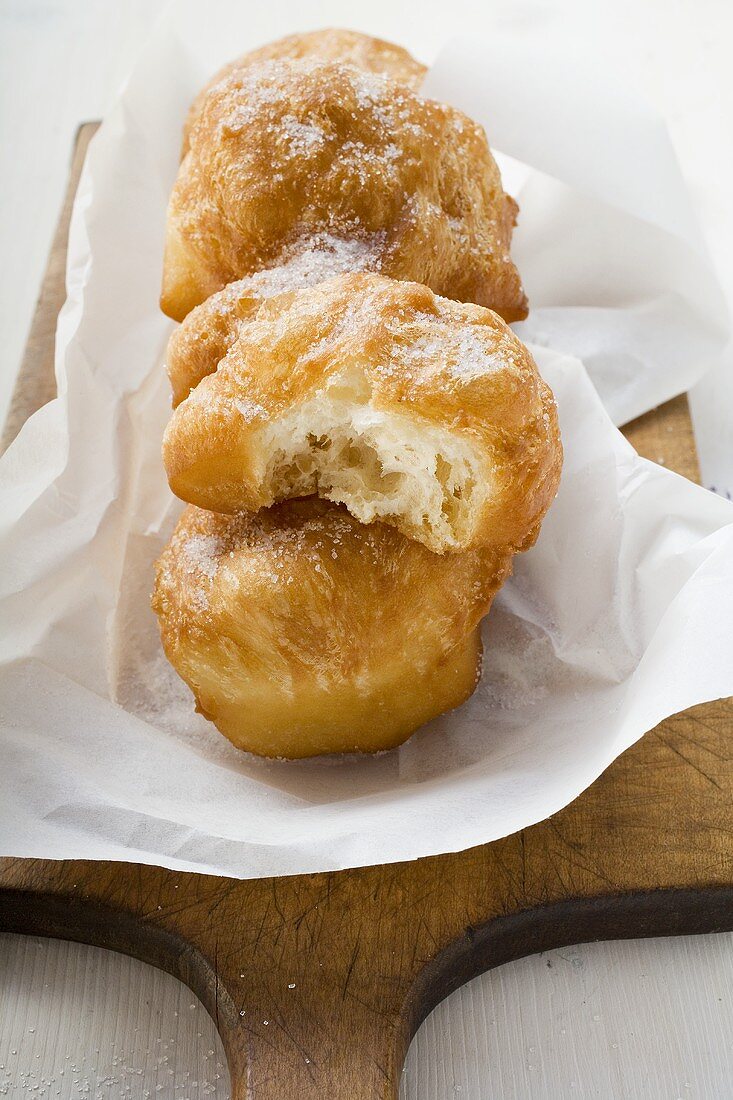 Fried pastries, sugared, on paper