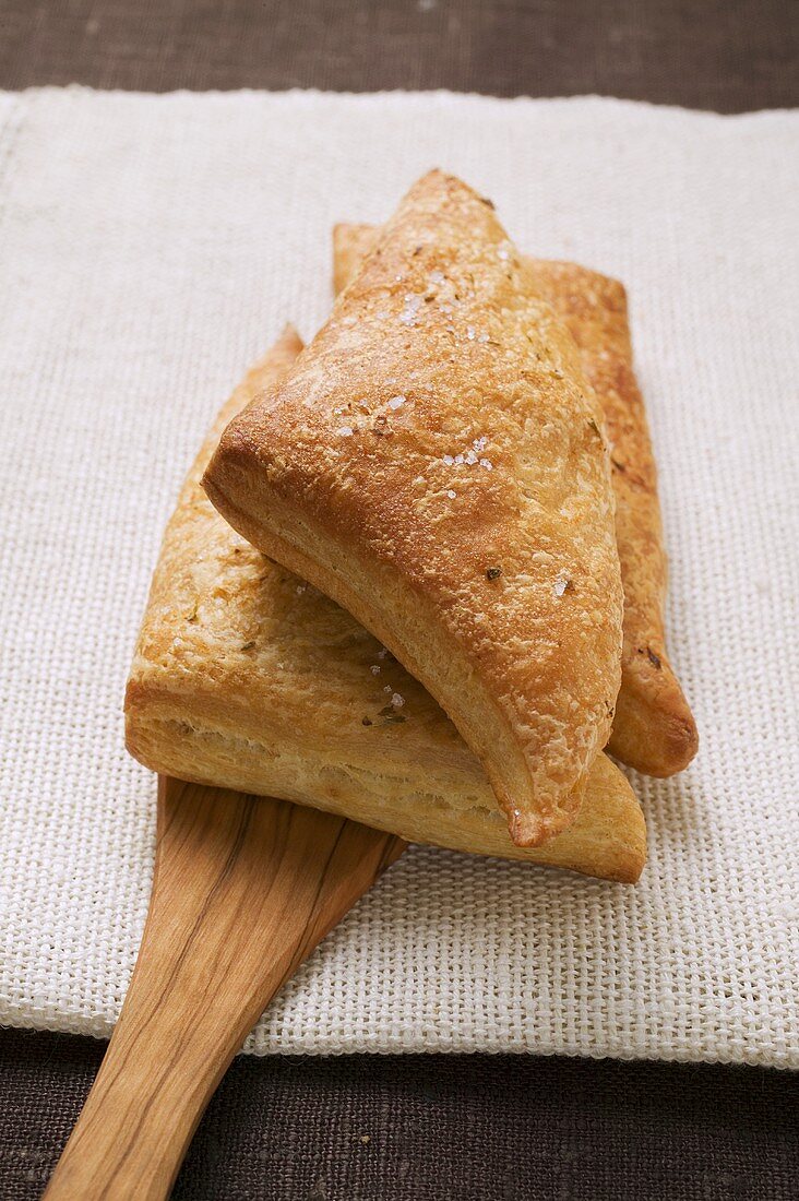 Triangular savoury puff pastry pasties on server
