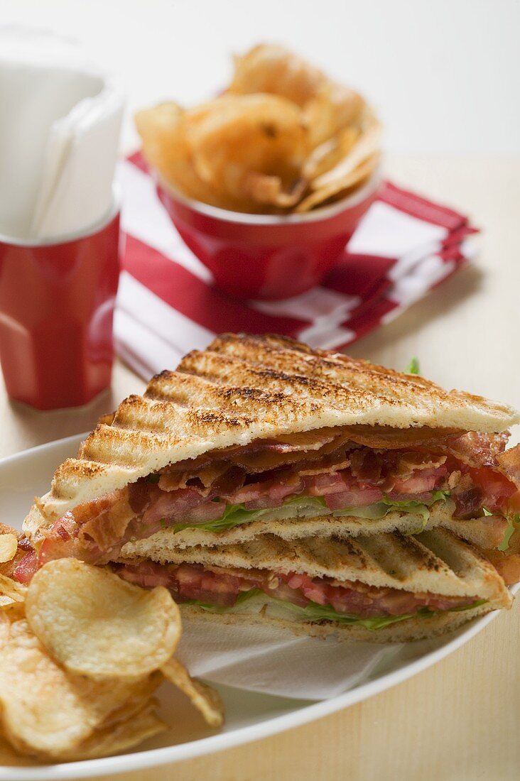 BLT sandwiches, toasted, with crisps