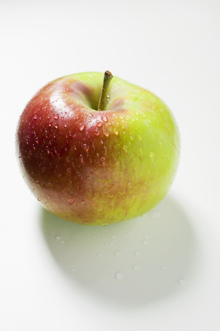 A fresh apple with drops of water