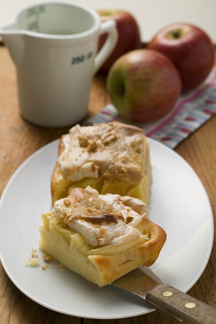 Two pieces of apple meringue cake, fresh apples & milk