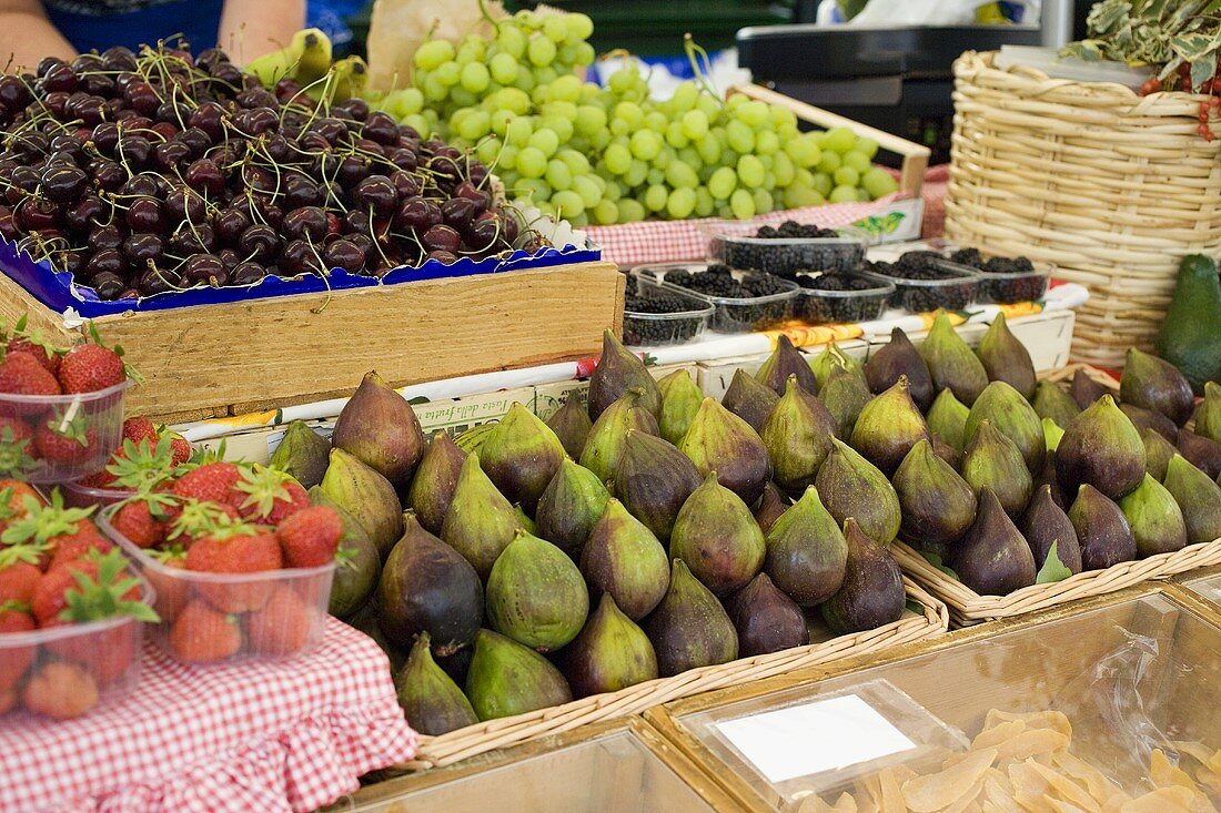 Fresh figs, cherries, grapes and berries at a market