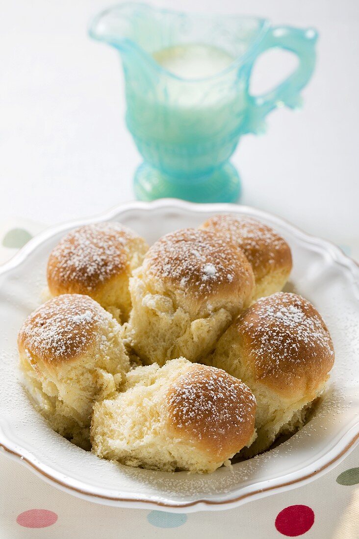 Sweet yeast dumplings (Buchteln) with icing sugar & custard