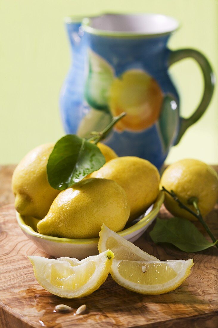 Lemon wedges and lemons with leaves