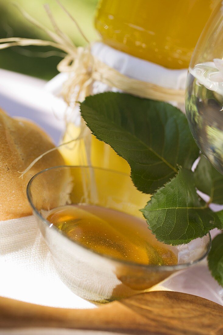 Honey in glass bowl in front of jars of honey