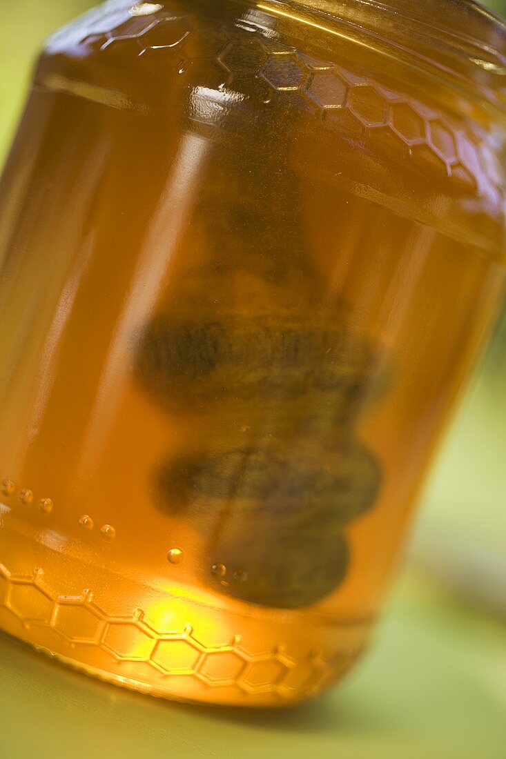 Jar of honey with honey dipper