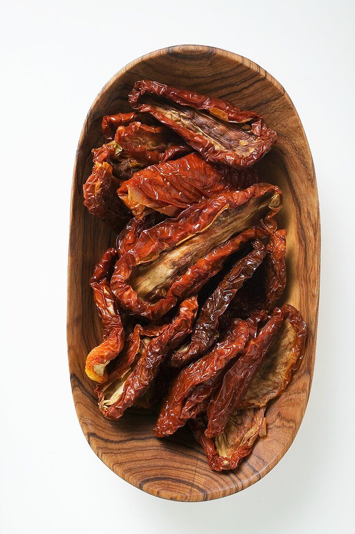 Dried tomatoes in wooden bowl