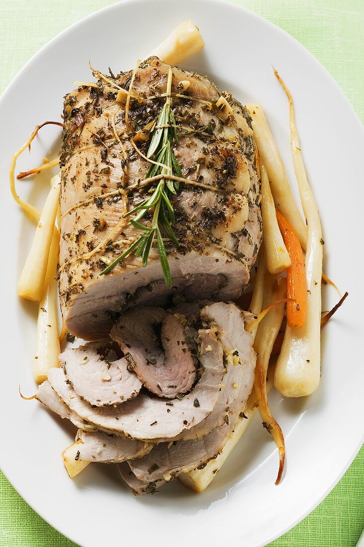 Roast turkey roll with root vegetables and herbs