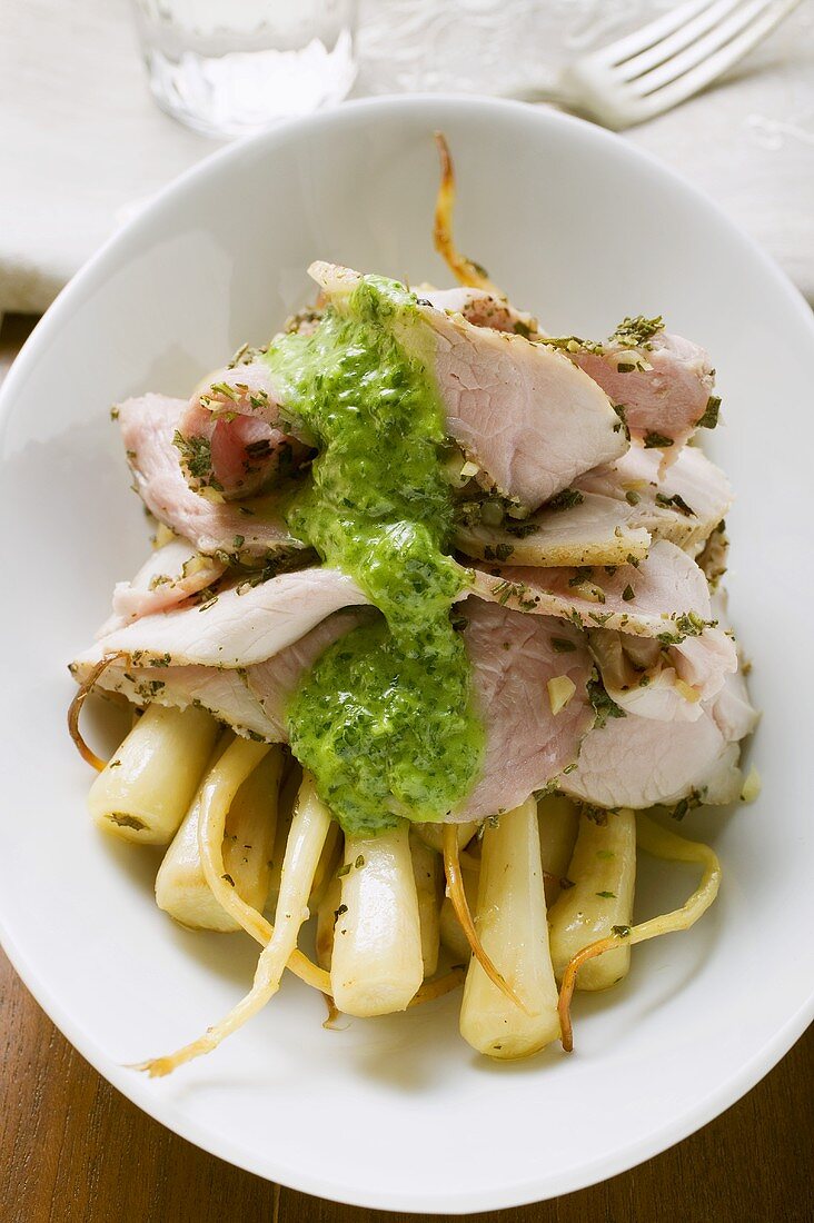 Turkey with herb sauce on root vegetables