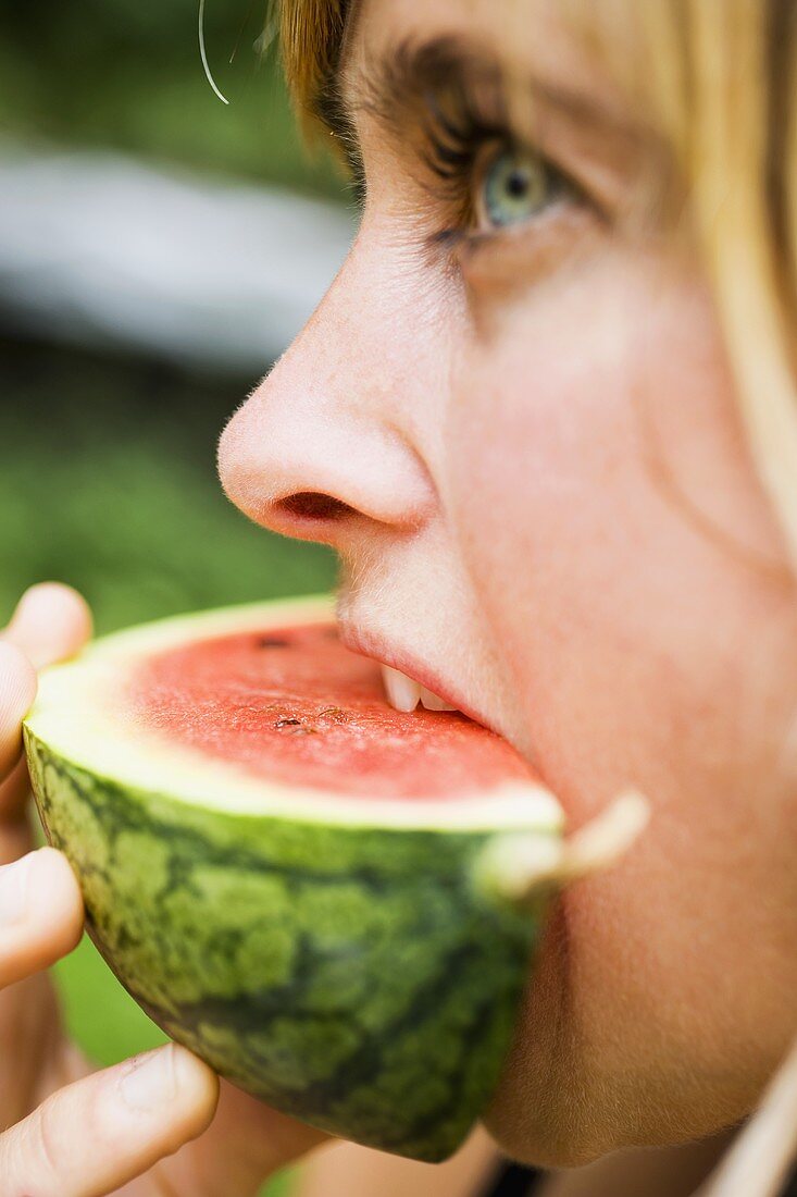 Woman eating fresh watermelon