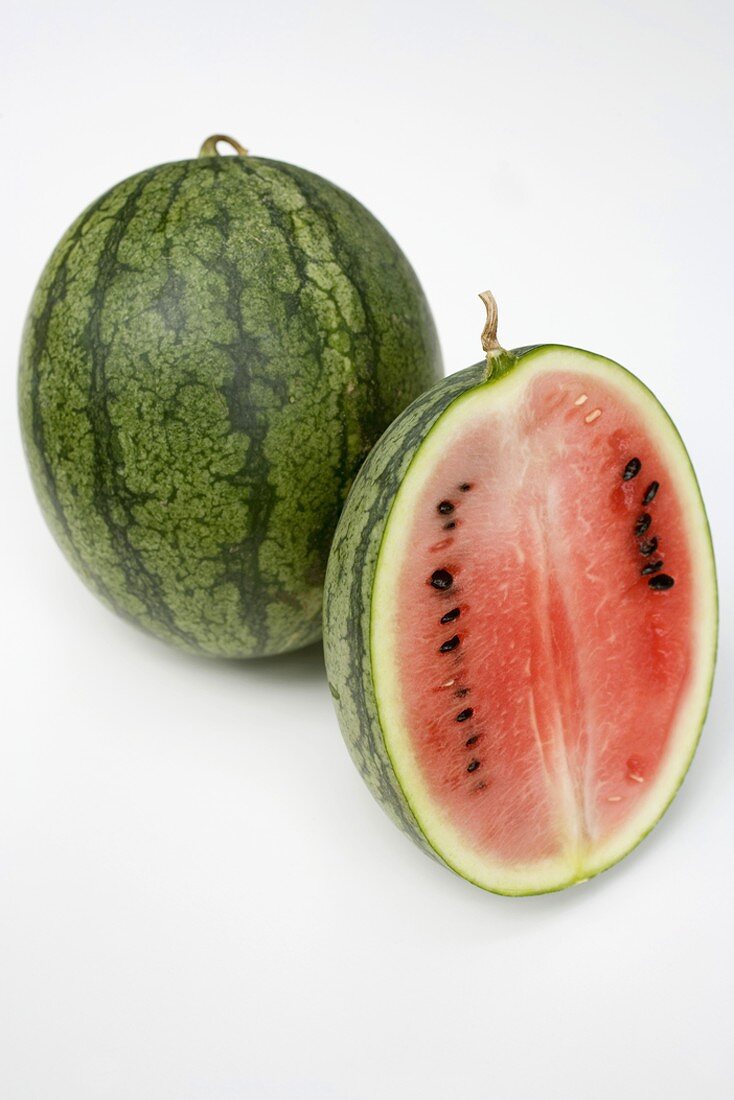 Whole and half of a watermelon