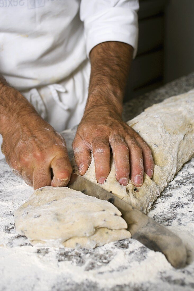 Making olive bread (dividing the dough into portions)