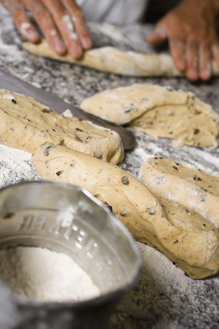 Making olive bread (forming into sticks)