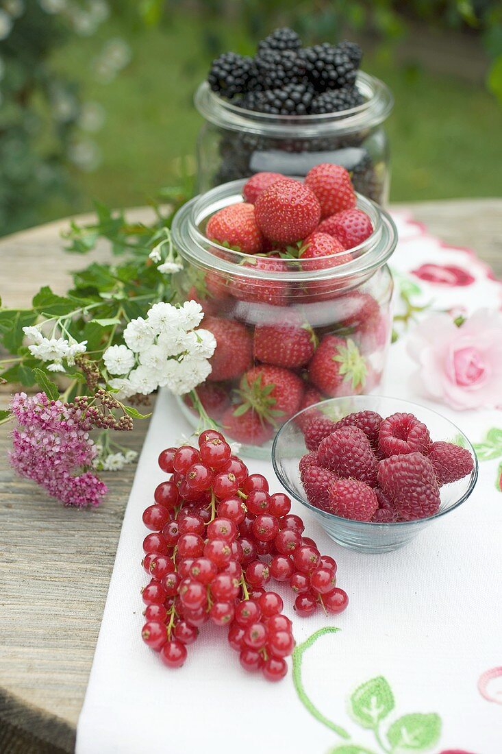 Fresh berries on rustic table out of doors