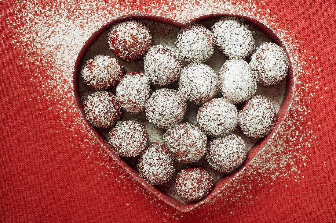 Sugared strawberries in heart-shaped dish