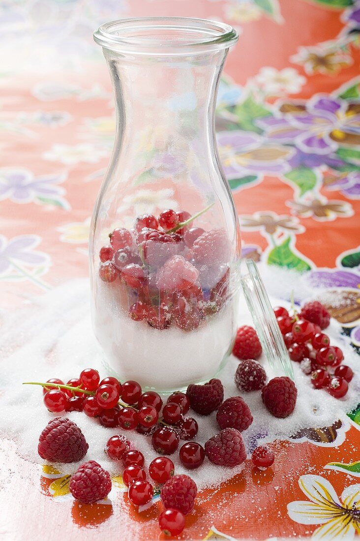 Fresh berries with sugar in carafe