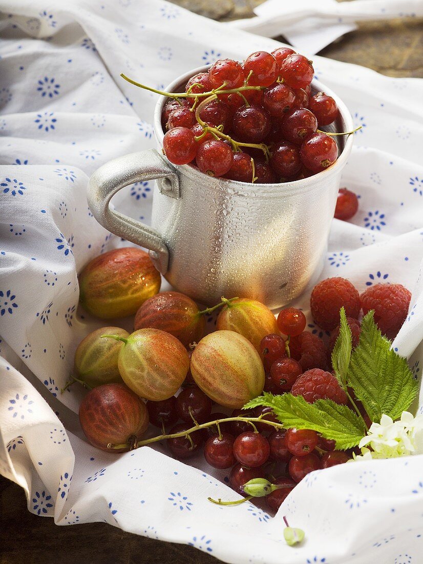 Assorted berries, some in metal cup