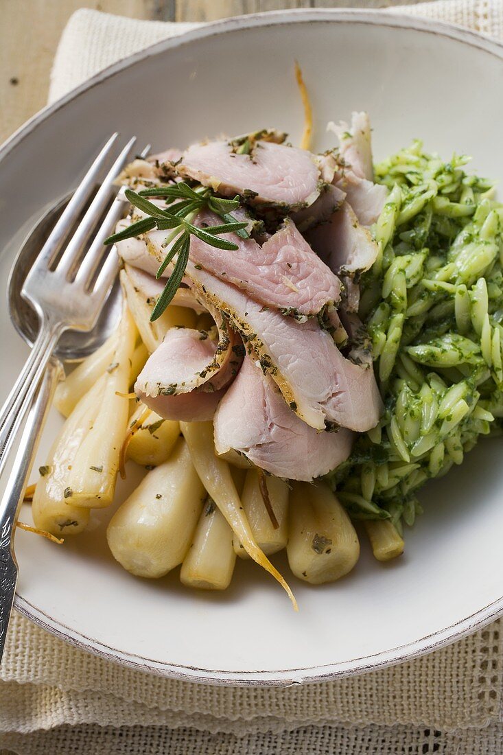 Rolled pork roast with parsley roots and orzo