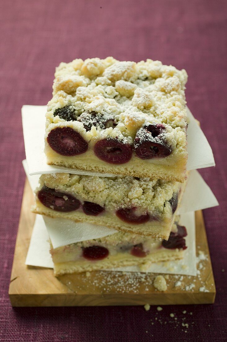 Three pieces of cherry crumble cake in a pile