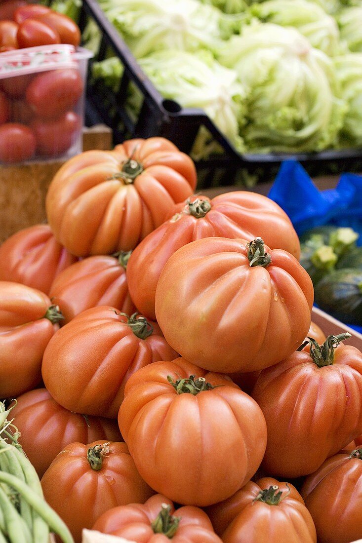 Large beefsteak tomatoes in a crate at a market