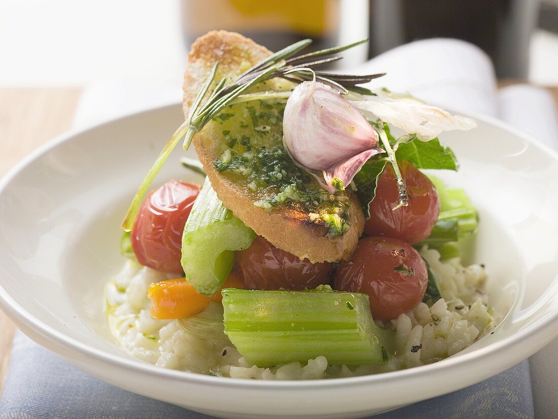 Risotto with vegetables, crostini, pesto and rosemary