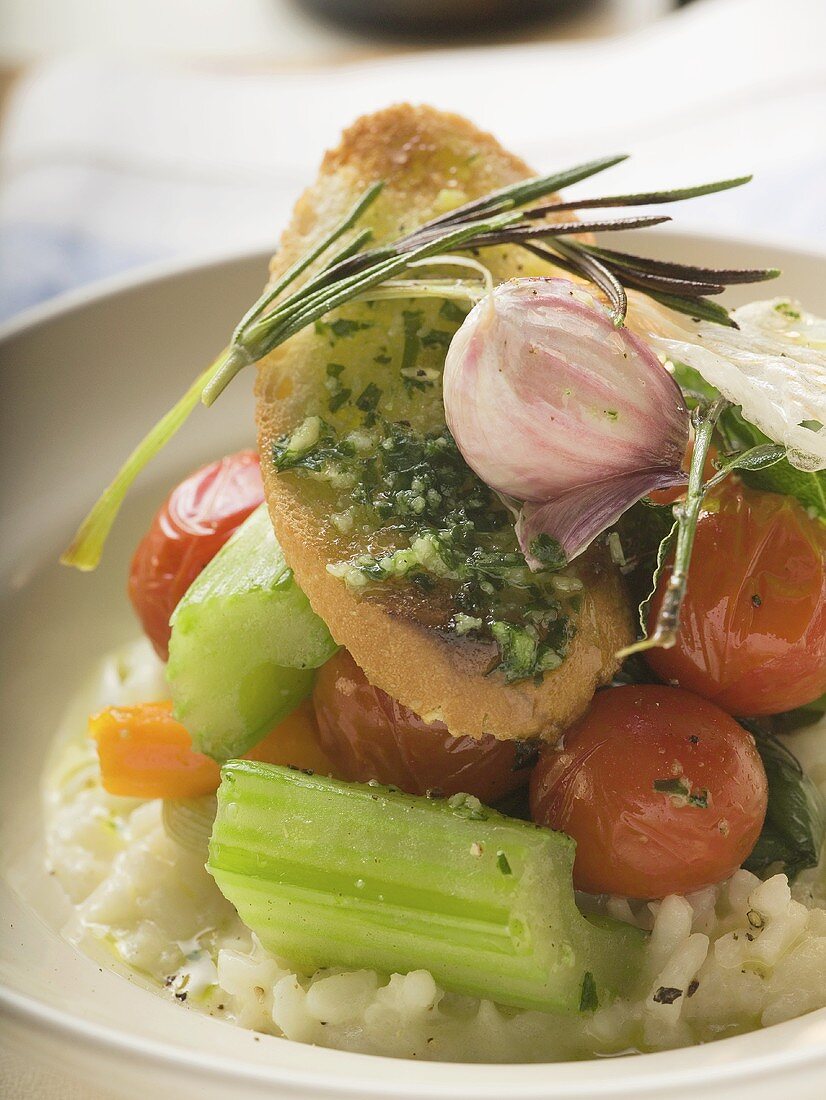 Risotto with vegetables, crostini, pesto and rosemary