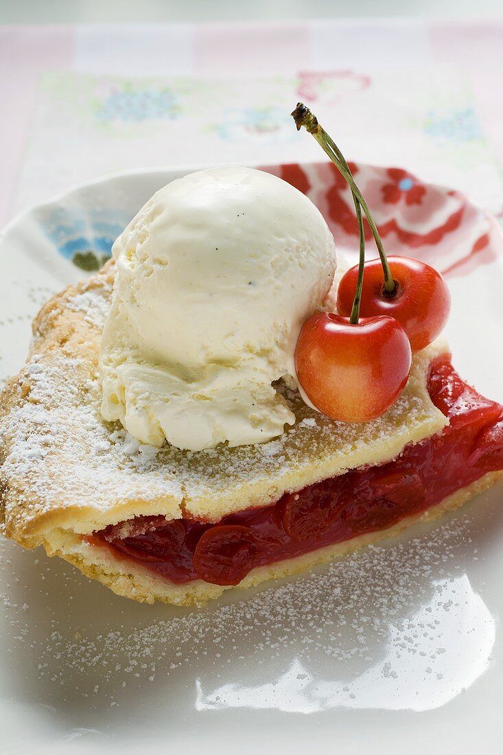 Piece of cherry pie with vanilla ice cream & fresh cherries (USA)