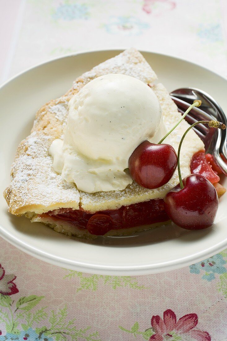 Piece of cherry pie with vanilla ice cream & fresh cherries (USA)