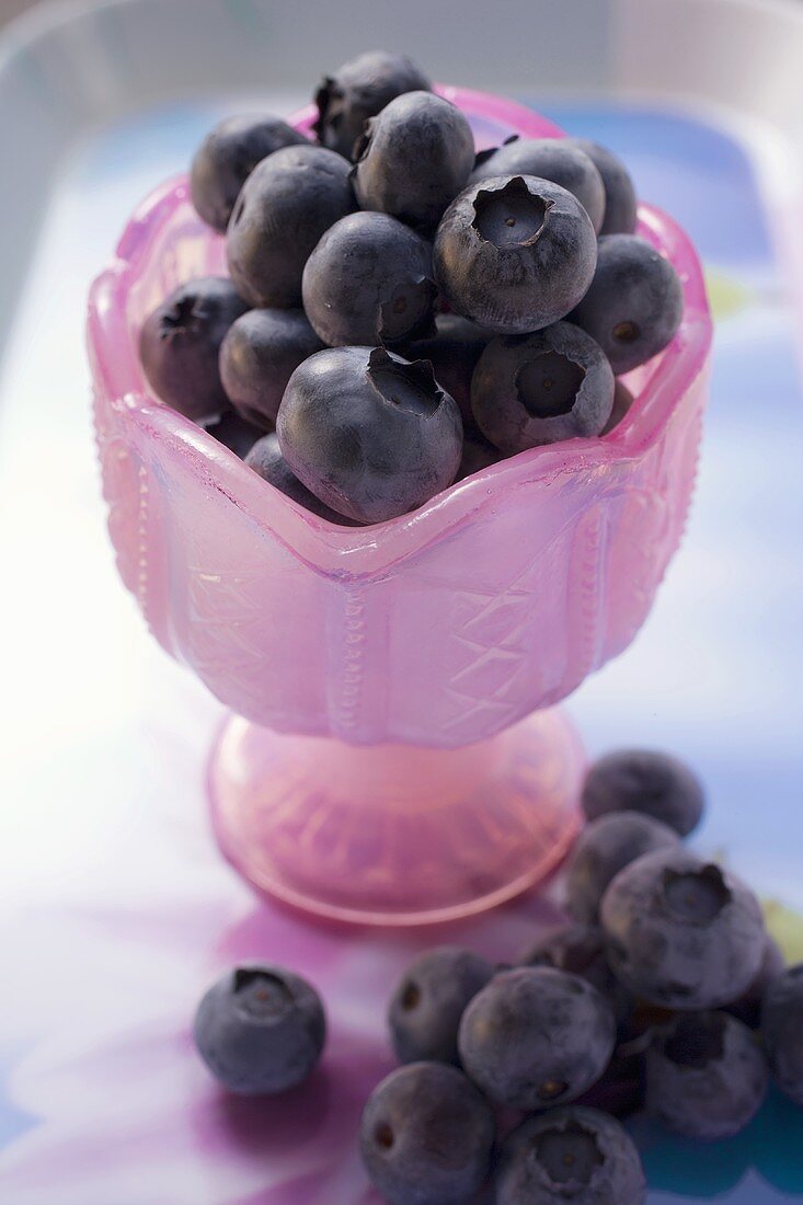 Fresh blueberries in pink glass goblet