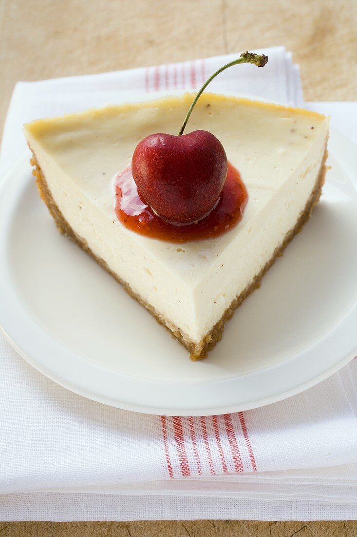 Stück Käsekuchen mit Kirsche