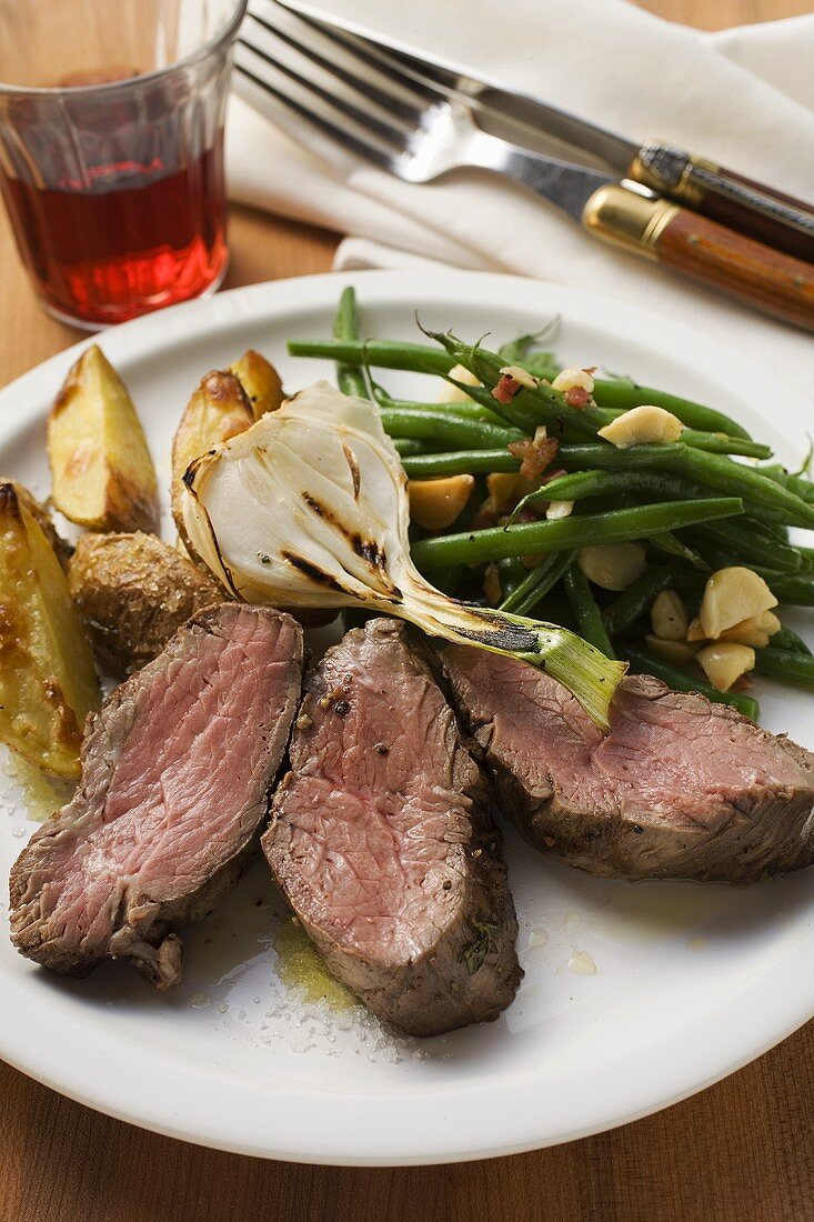 Beef steak with potato wedges, spring onion, beans & bacon