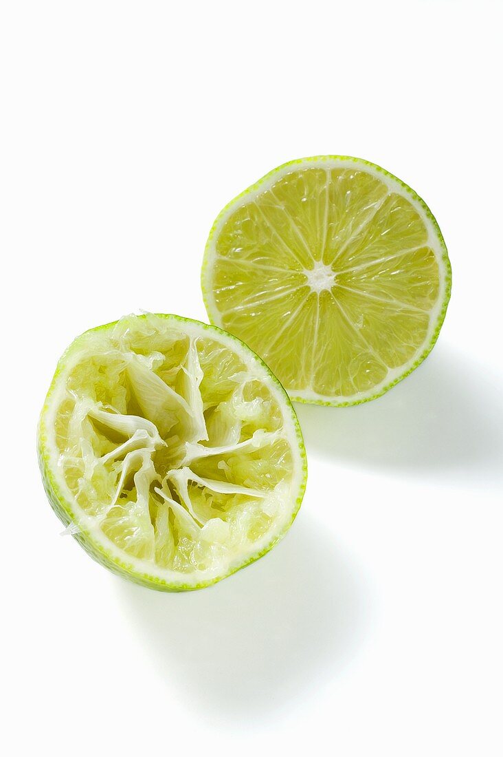 Two lime halves, one squeezed
