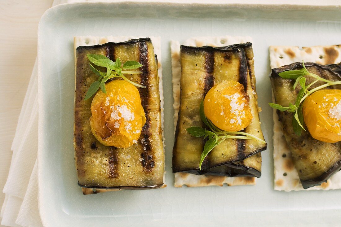 Aubergine rolls and cherry tomatoes on crispbread