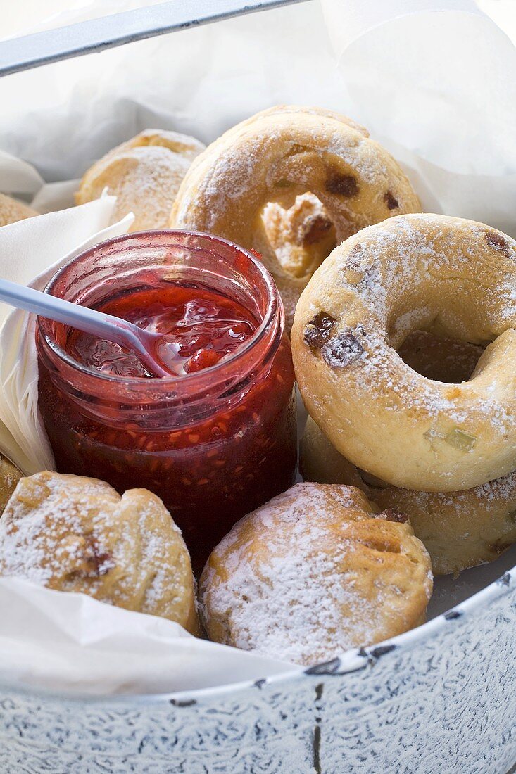 Raisin buns and jar of berry jam