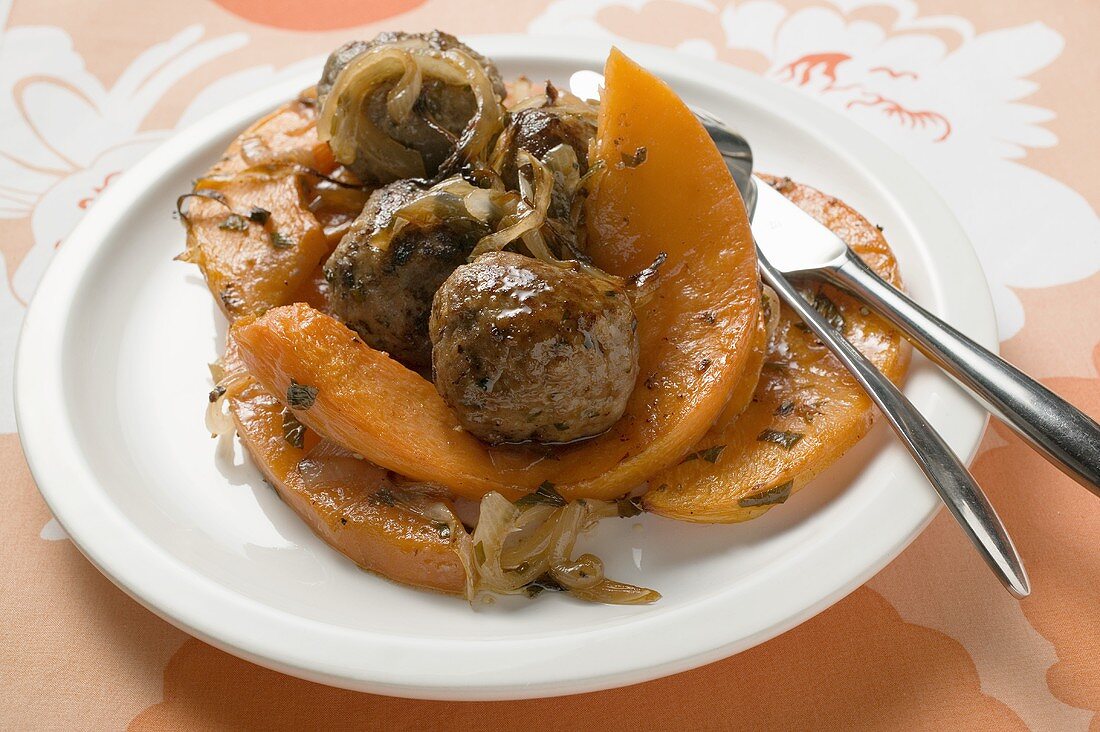 Meatballs with roasted pumpkin slices on plate