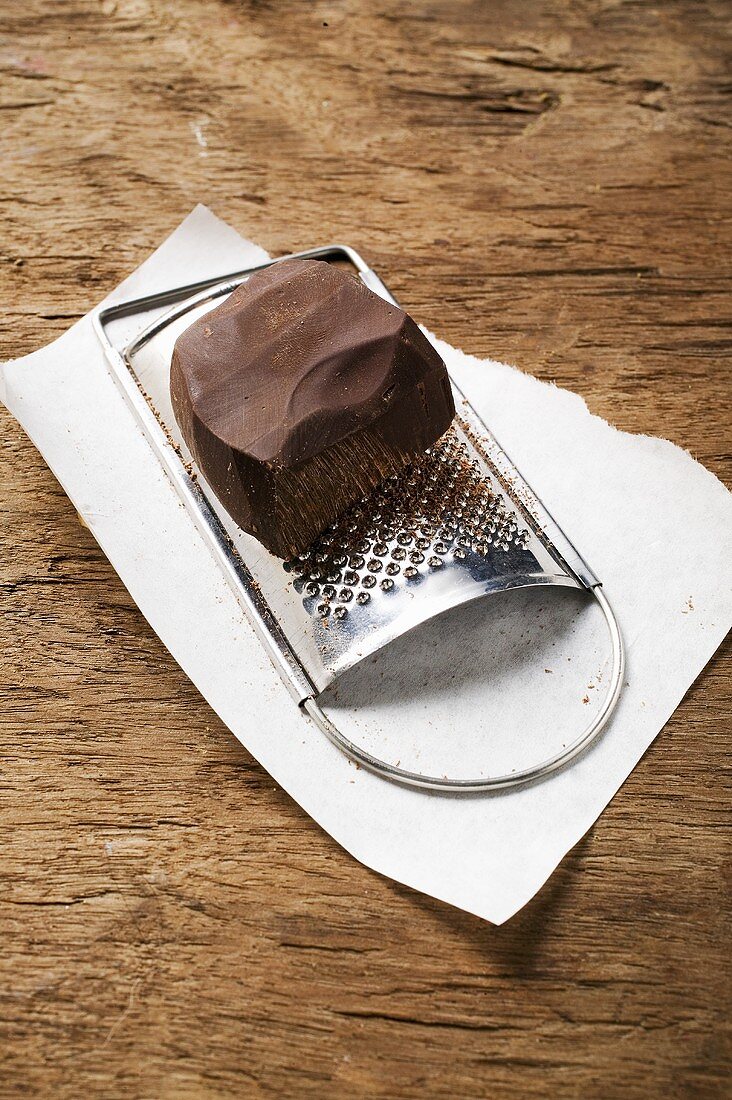 Piece of chocolate on grater