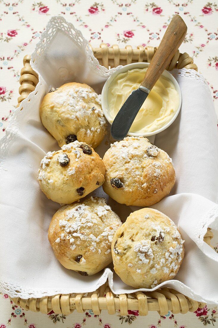 Sugared raisin scones & small dish of butter in bread basket