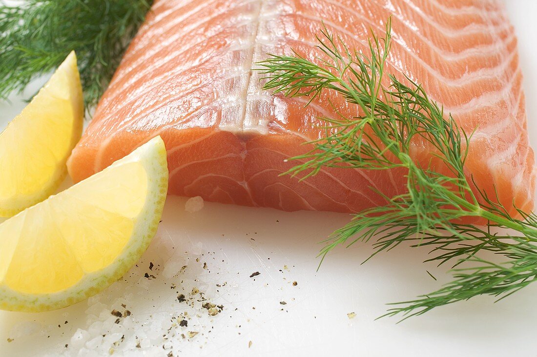 Salmon fillet, dill and lemon wedges