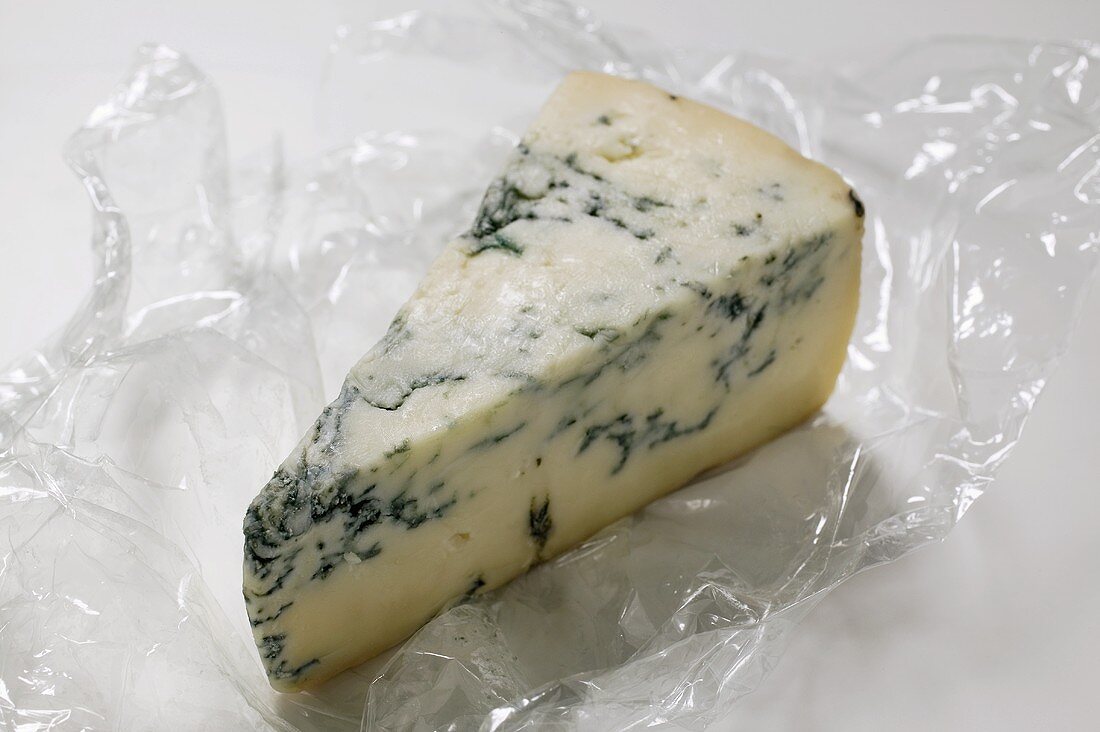Piece of blue cheese on clingfilm