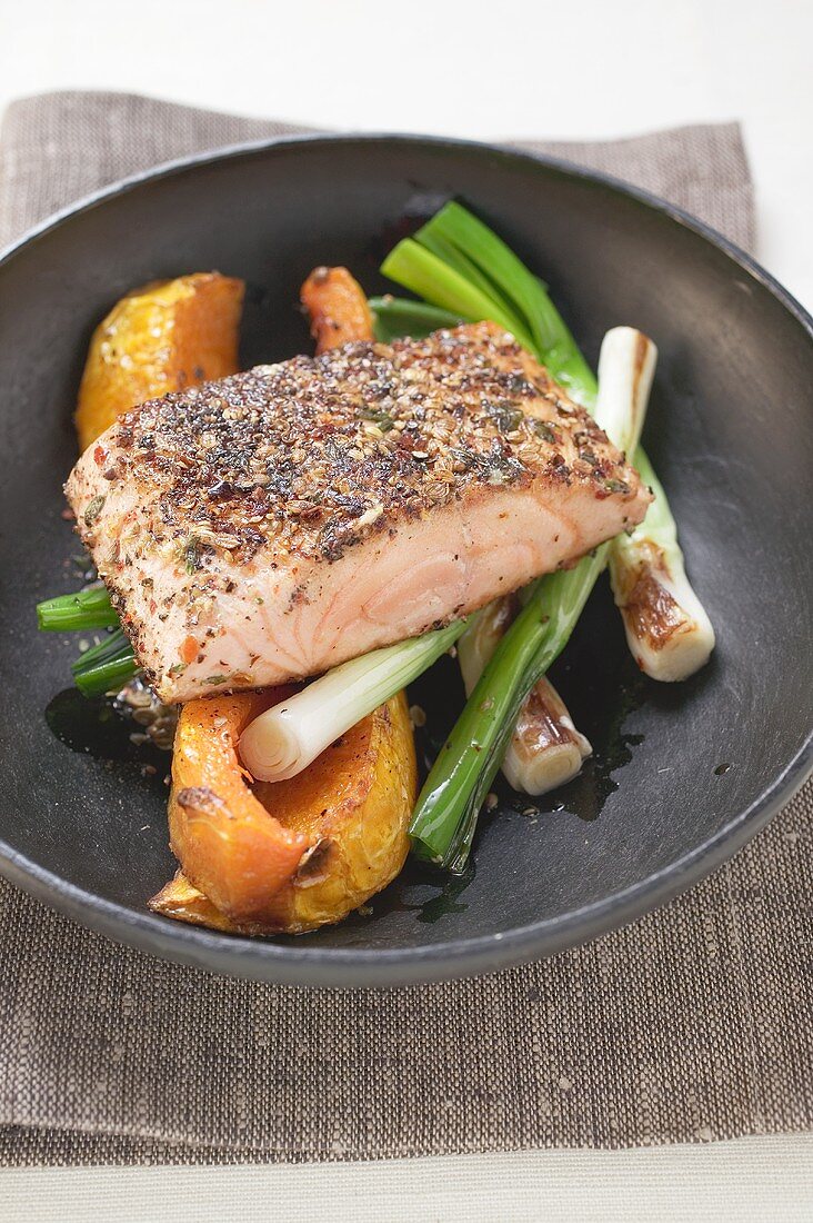 Fried salmon fillet on vegetables