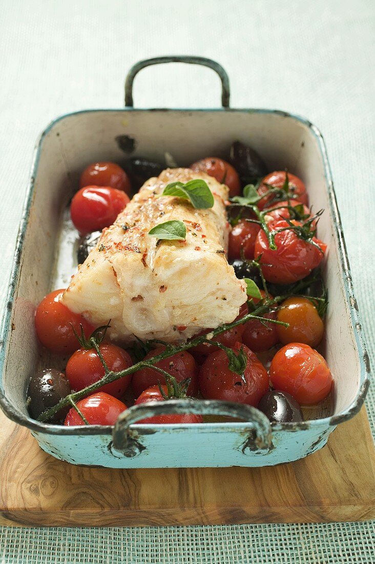 Monkfish with cherry tomatoes and olives in roasting tin