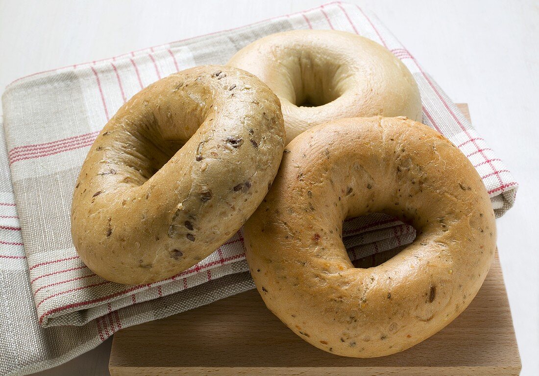 Three different bagels on tea towel